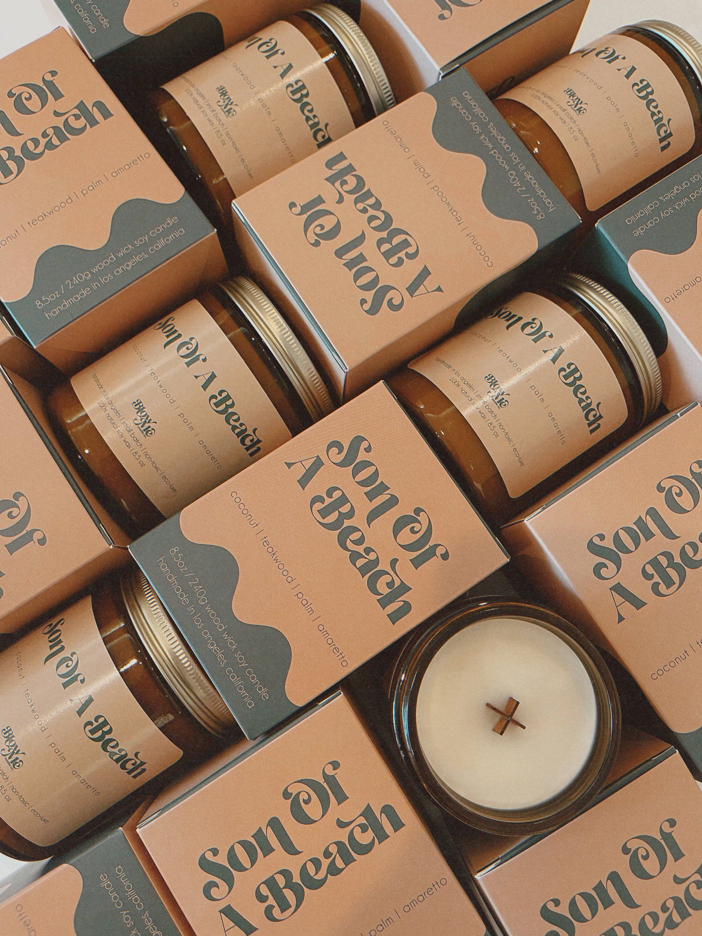 Candle jars with 'Son of a Beach' packaging on a white background