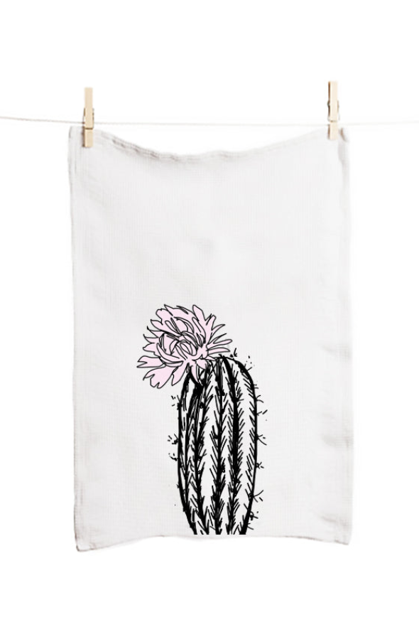 White towel with a black cactus design hanging on a clothesline.