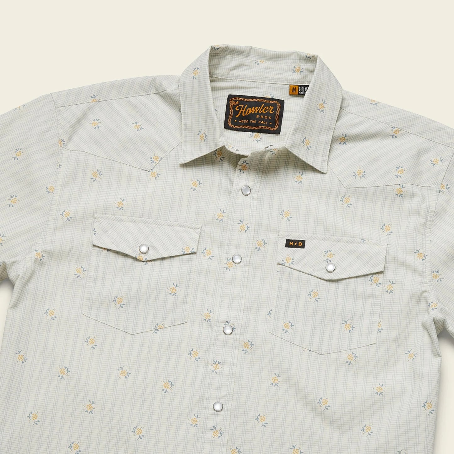 Light gray shirt with subtle pattern on a beige background
