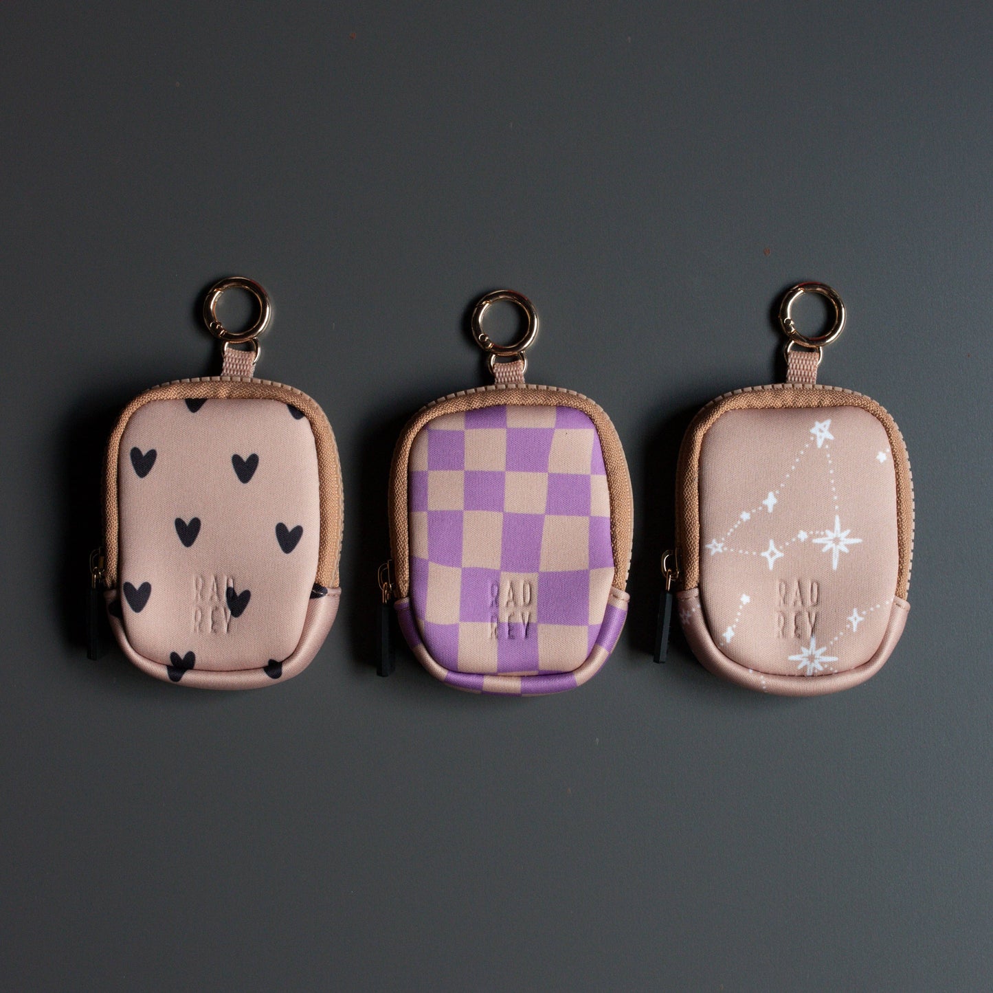 Three small pouches with different patterns on a dark background