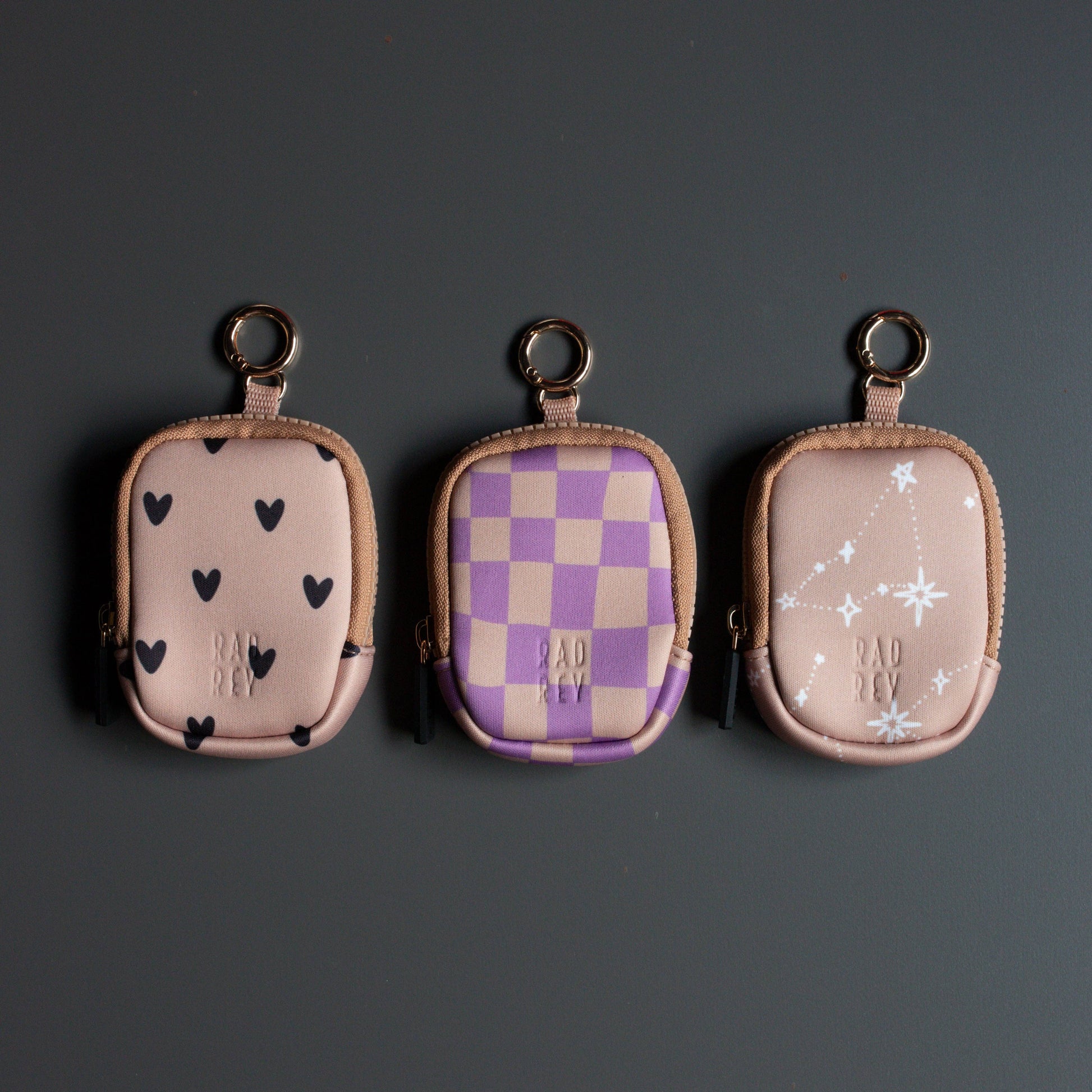 Three small pouches with different patterns on a dark background