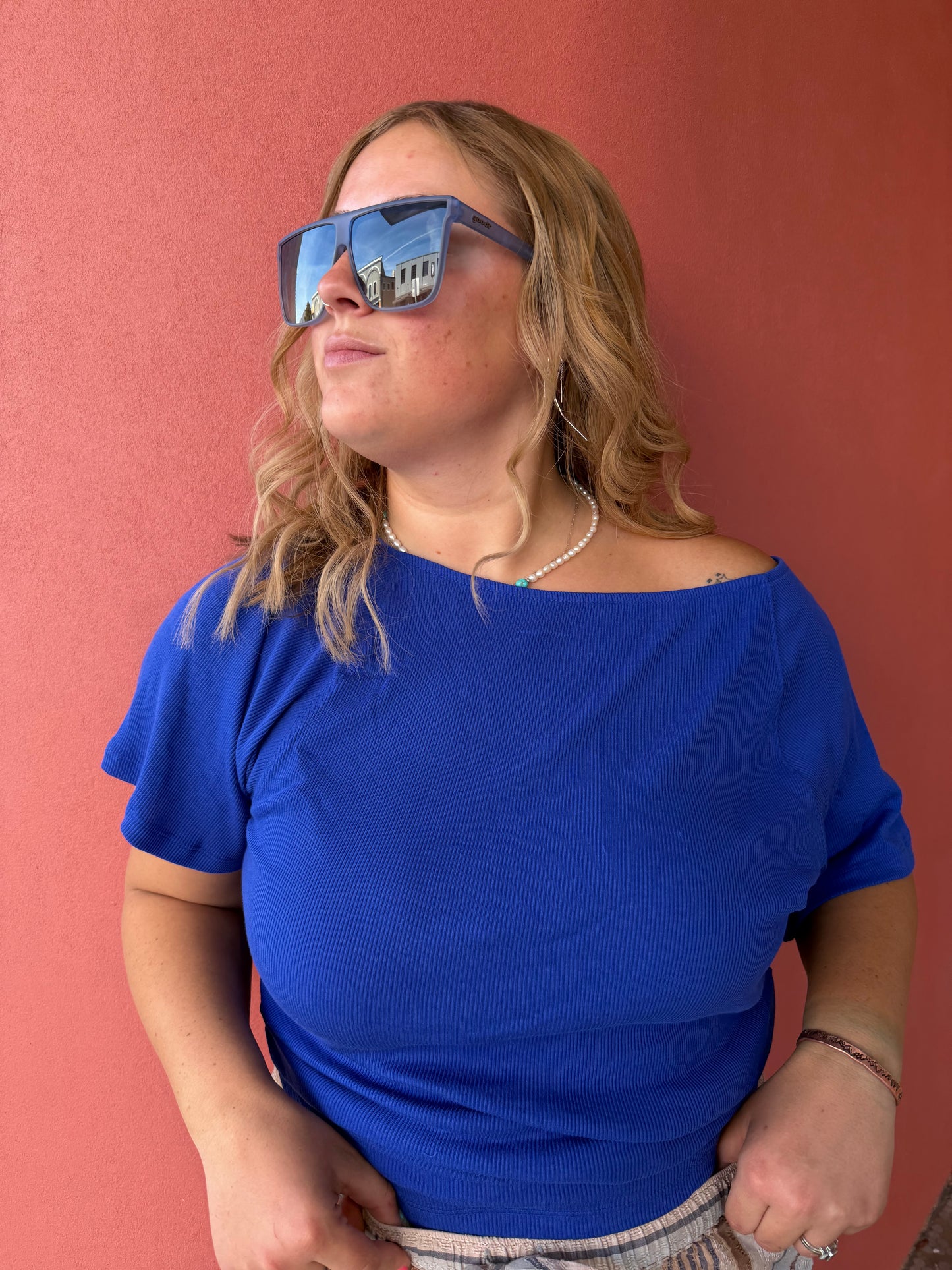 Person wearing a blue shirt on a red background