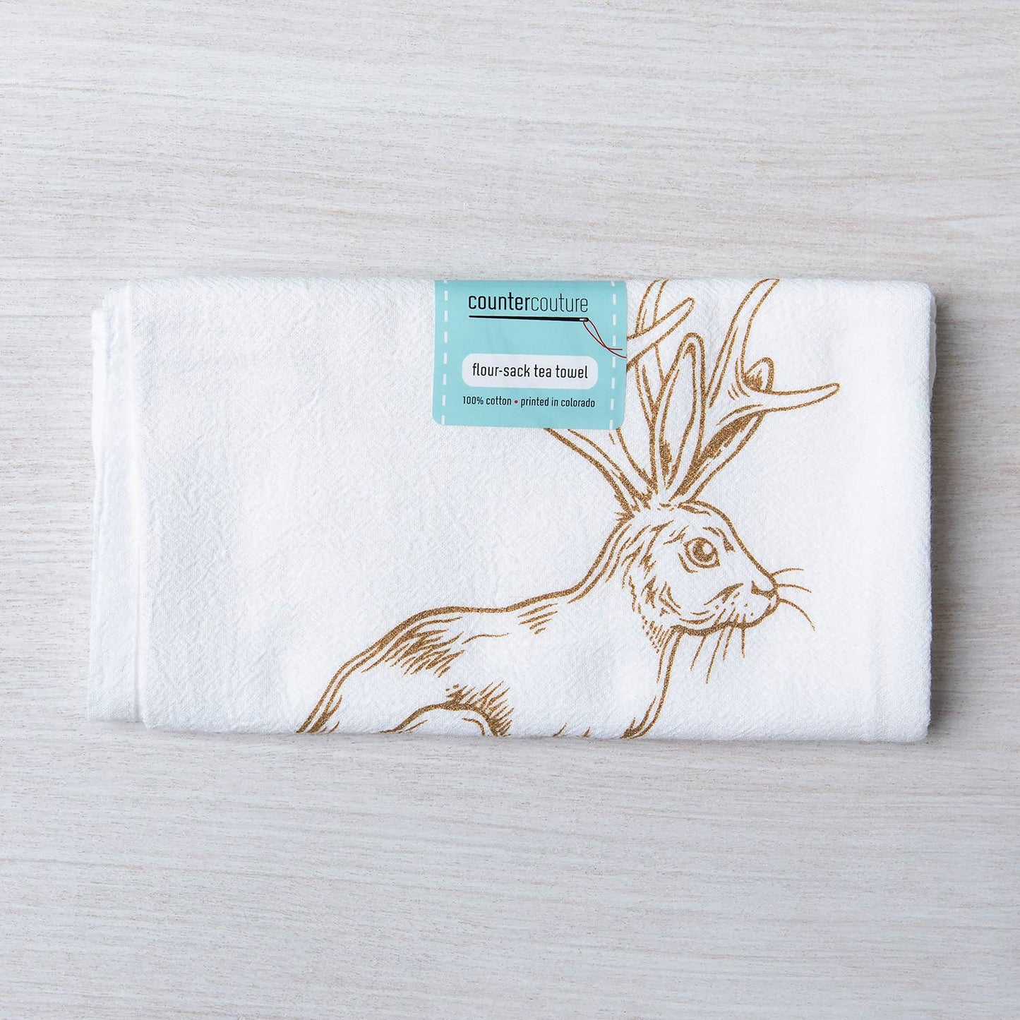 Flour-sack tea towel with hare design and 'counter couture' label on a light gray background