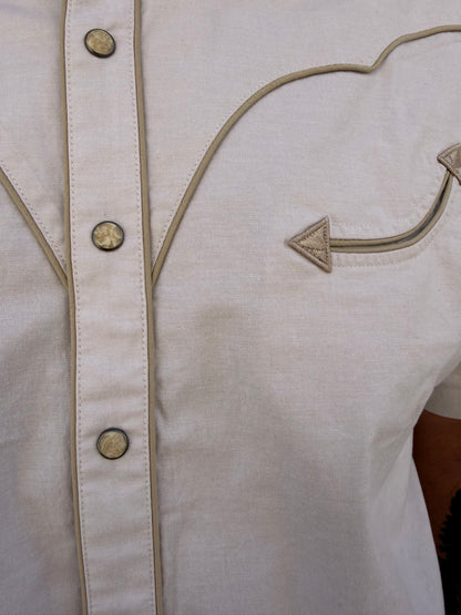 Close-up of a beige garment with decorative buttons and stitching
