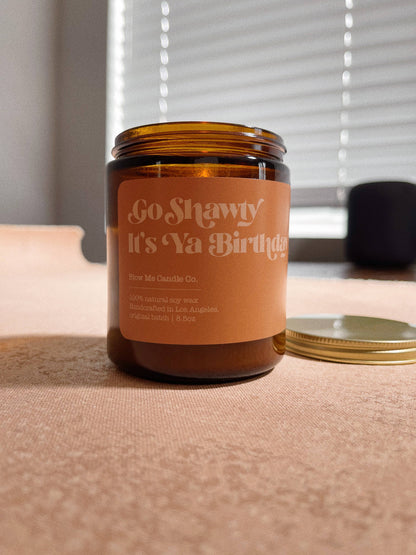 Candle jar with a humorous label on a table