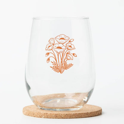 Clear glass with floral design on a cork coaster
