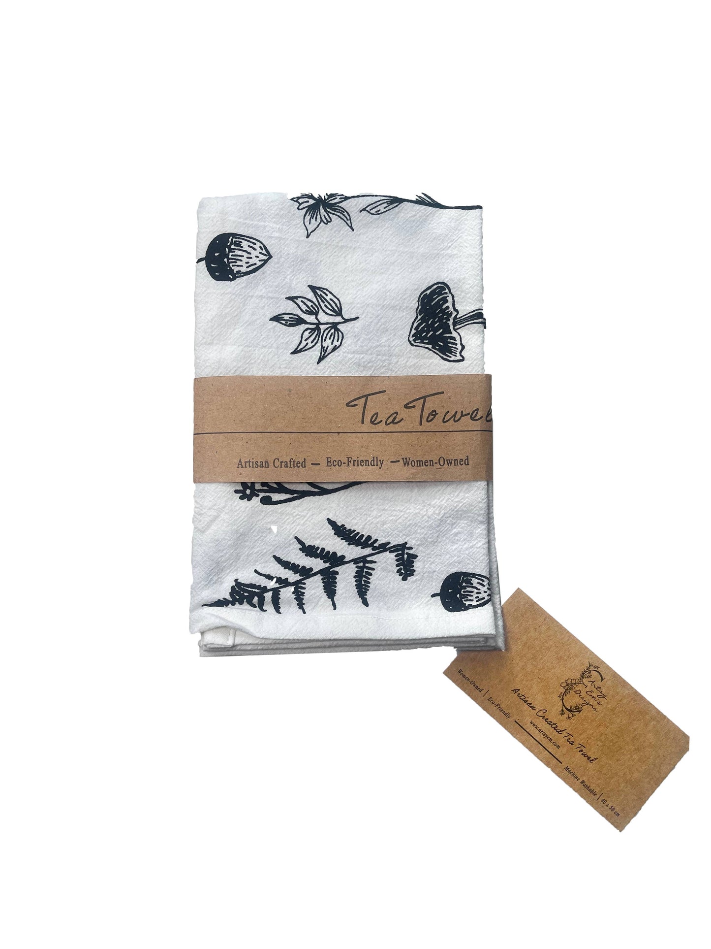 Tea towel with black leaf pattern and brown label on a white background