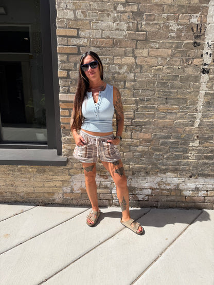 Person standing on a stone pavement with a building in the background
