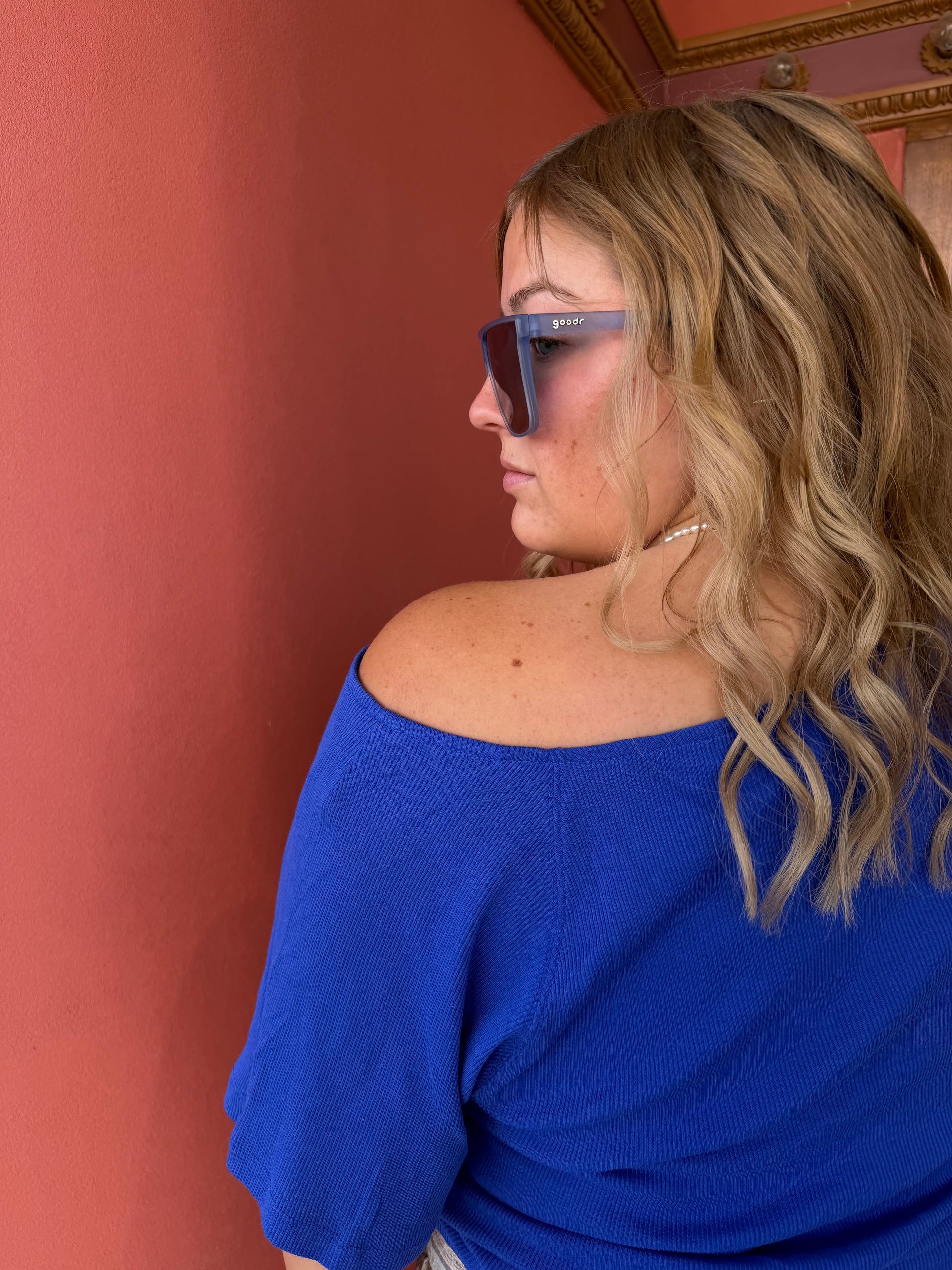 Person wearing a blue top with a blurred background