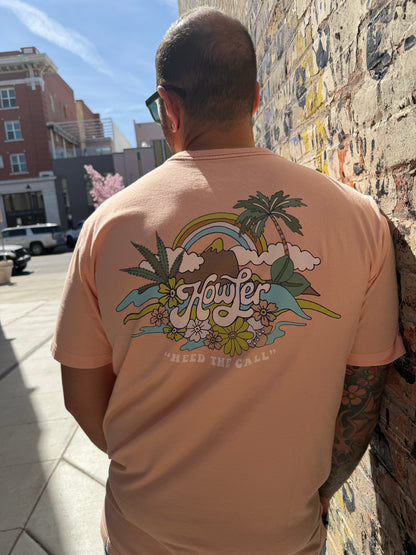 Person wearing a pink t-shirt with a colorful graphic design outdoors.