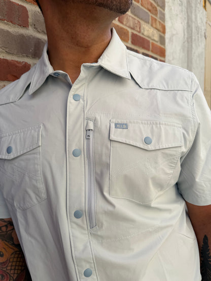 Light-colored denim jacket with button details on a textured surface
