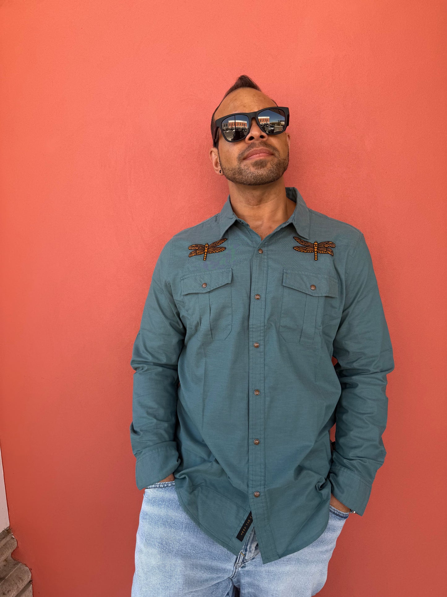 Man wearing a blue jacket against a red background