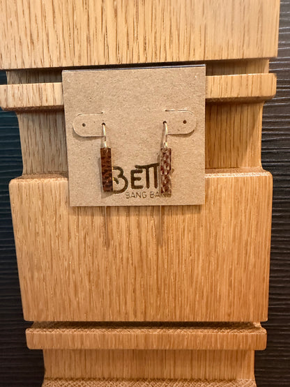 Close-up of a wooden product with a label featuring the brand 'Betty Bang Bangt'.
