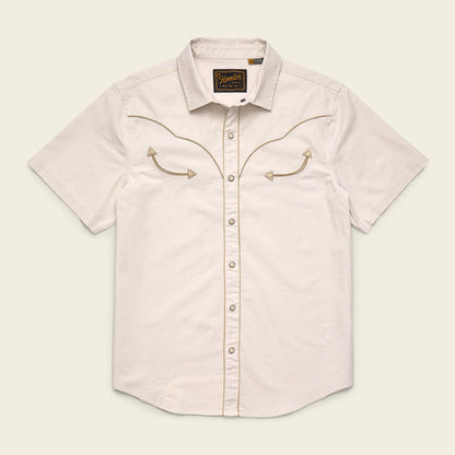 Light pink short-sleeve shirt with embroidered details on a beige background