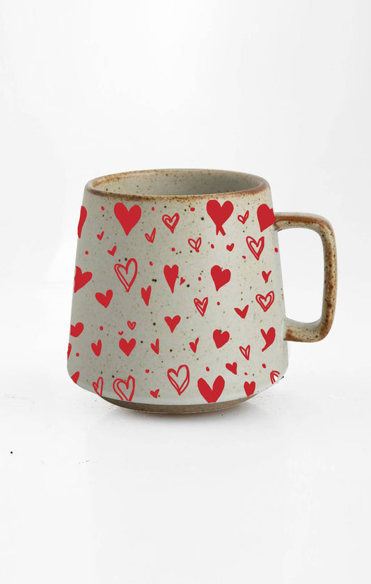 Ceramic mug with red heart pattern on a white background